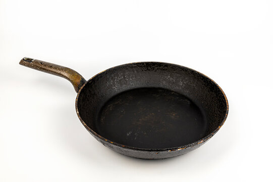 An old dirty frying pan. The concept of dirty pans.