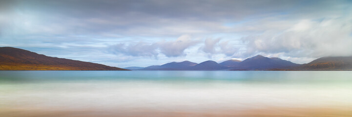 Luskentyre Beach Panoramic with  clouds in he sky and a golden beach