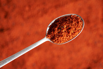 Top view of sea buckthorn powder on a spoon