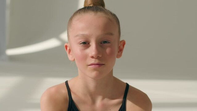 Portrait Caucasian little girl teen child kid daughter schoolgirl young pupil of ballet school female gymnast ballerina in dance studio sport gymnastics teenager look camera children custody adoption