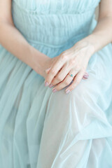 Woman in Blue Dress Holding Hands Together