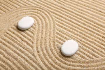 White spa stones on light sand