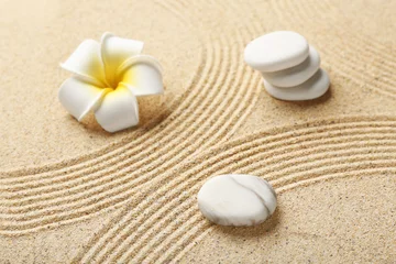 Tuinposter Spa stones and plumeria on light sand with lines. Zen concept © Pixel-Shot