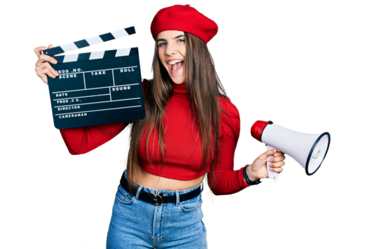Young brunette teenager holding video film clapboard and megaphone smiling and laughing hard out loud because funny crazy joke.