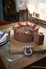 chocolate cake with strawberries on the table