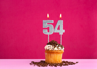 Birthday cupcake with candle number 54 - Birthday card on pink background
