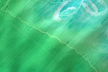 Green fabric with transversal fibers, horizontal abstract background