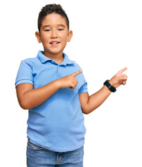 Little boy hispanic kid wearing casual clothes smiling and looking at the camera pointing with two...
