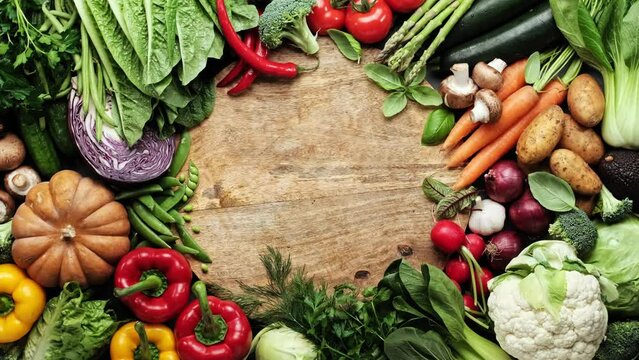 Vegetables set and space for a text or a product. Vegetables backdrop. Variety of fresh vegetables, food background, top view, stock footage video 4k
