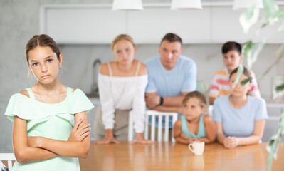 Offended teenage girl turned away from her big family. family quarrel
