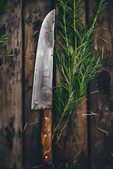 Foto op Plexiglas A knife and a sprig of rosemary on a rustic wooden table. Ideal for food or cooking concepts © Fotograf