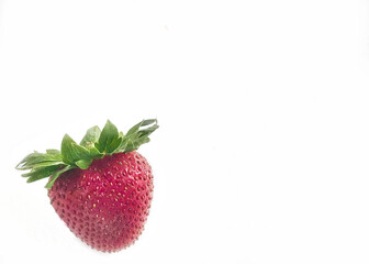 Whole strawberry on a white background with copy space
