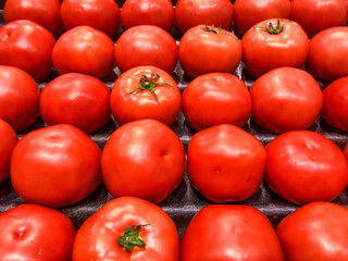 Whole, ripe, red tomatoes on display for sale