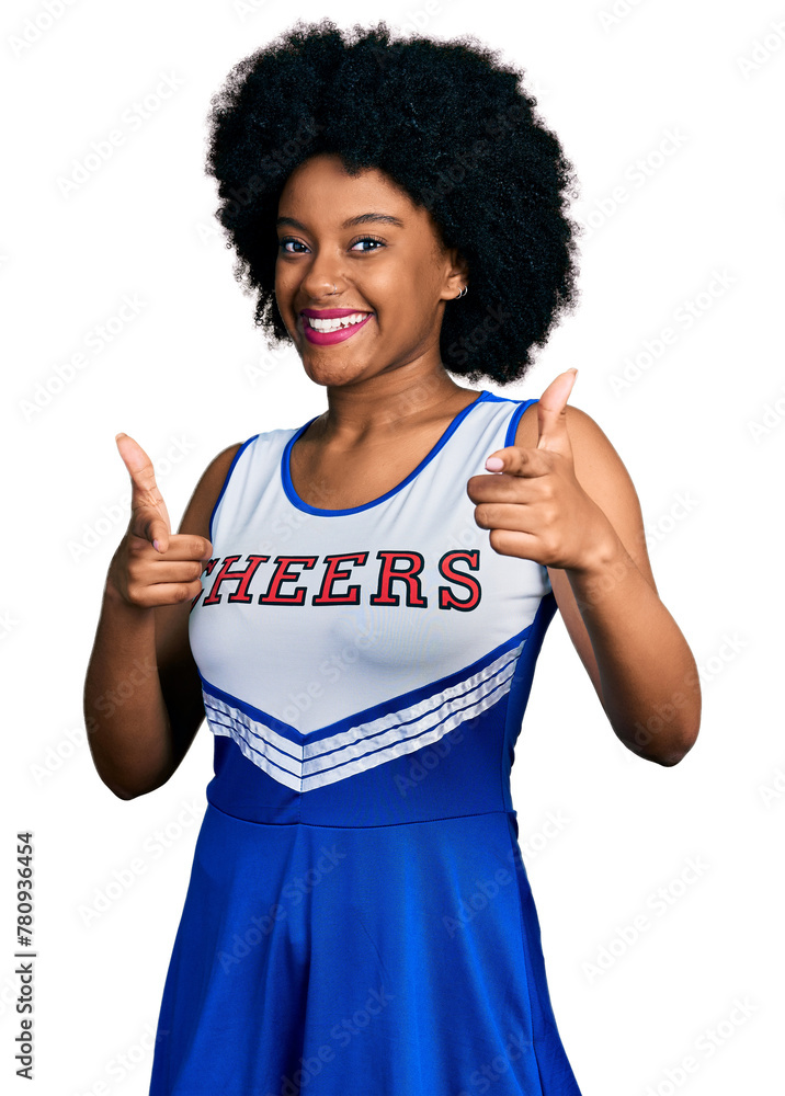 Sticker Young african american woman wearing cheerleader uniform pointing fingers to camera with happy and funny face. good energy and vibes.