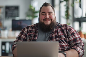 A man sitting at a table with a laptop. Ideal for illustrating modern work environments