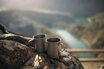 Couple of camping mugs on the wood at canyon viewpoint