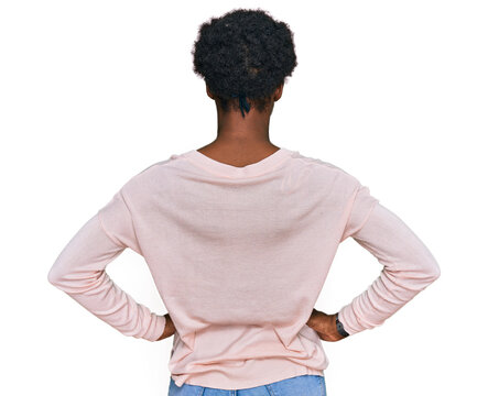 Young african american girl wearing casual clothes standing backwards looking away with arms on body