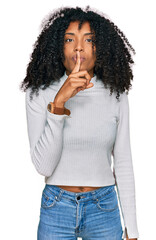 Young african american girl wearing casual clothes asking to be quiet with finger on lips. silence...