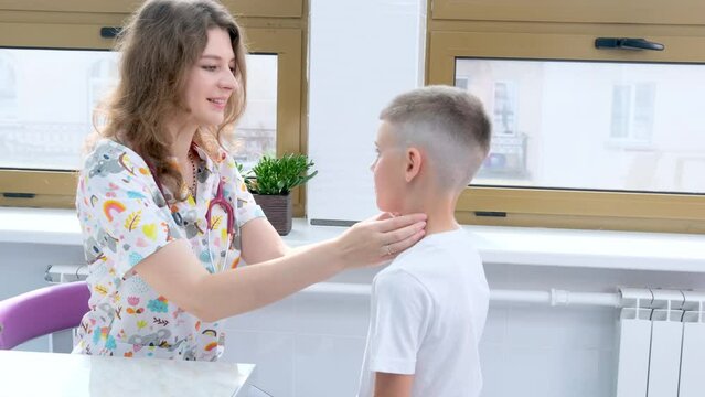 a female doctor checks the lymph nodes of a boy