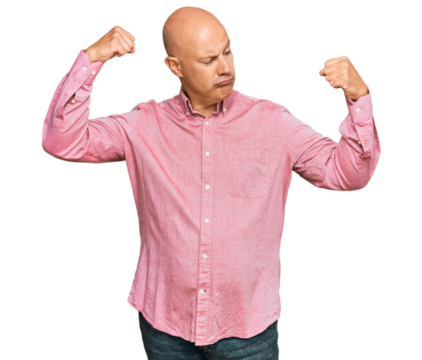 Middle age bald man wearing casual clothes showing arms muscles smiling proud. fitness concept.