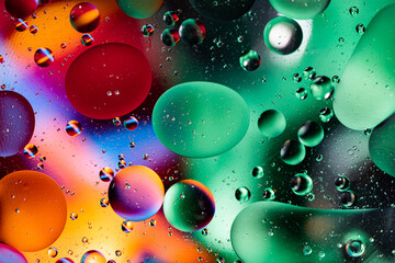 Colorful abstraction of oil bubbles in water. View from above. Macro photography.