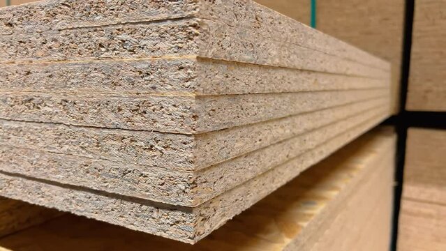 New Particle Board Sheets in Stock. Premium Construction Materials for Your Home Renovation and DIY Projects. Stacked Chipboards and Boards Ready for Purchase at Hardware Store or Lumber Yard. Closeup