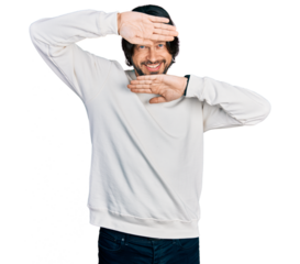 Middle age caucasian man wearing casual clothes smiling cheerful playing peek a boo with hands showing face. surprised and exited