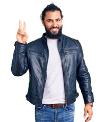 Young arab man wearing casual leather jacket showing and pointing up with fingers number two while smiling confident and happy.