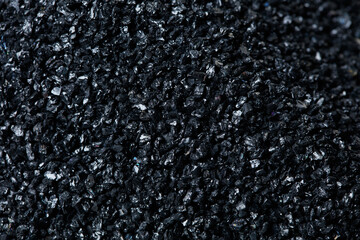 Macro close up of Silicon Carbide black sand size. Fine particle silicon carbide pile up, White background Isolated, particle element object