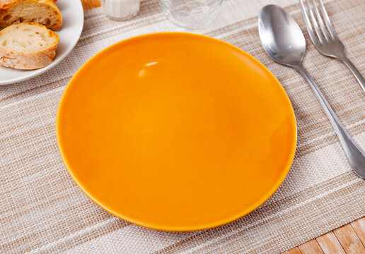 Table setting before the festive banquet - plate, knife and fork