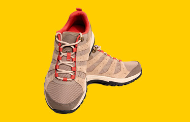 pair of comfortable New brown trekking sneakers, waterproof hiking boots with laces isolated on...