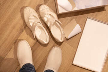 beige leather shoes, comfortable moccasins on female foot, trying, buying new shoes, modern natural...