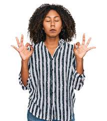 Young african american girl wearing casual clothes relax and smiling with eyes closed doing meditation gesture with fingers. yoga concept.