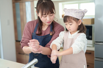 手を洗う女の子とお母さん - 780968442