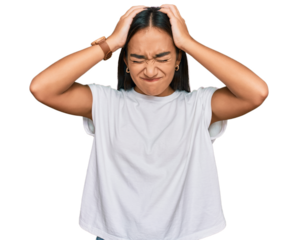 Young asian woman wearing casual white t shirt suffering from headache desperate and stressed because pain and migraine. hands on head.