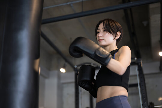 Front of cool, handsome woman boxing or exercising at gym Close-up