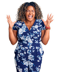 Young african american plus size woman wearing casual clothes celebrating mad and crazy for success...