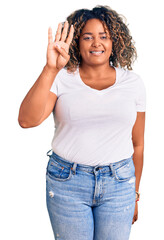 Young african american plus size woman wearing casual clothes showing and pointing up with fingers number four while smiling confident and happy.