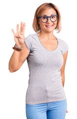 Young blonde woman wearing casual clothes showing and pointing up with fingers number four while smiling confident and happy.