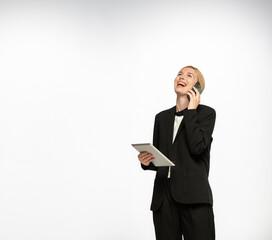 happy businesswoman with tablet and smartphone looking up with free space for text isolated - 780970278