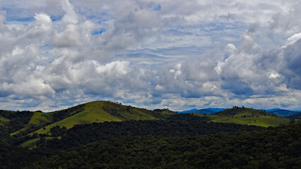Serra da Bocaina mountains on the horizon, under a dramatic sky covered by dark clouds.