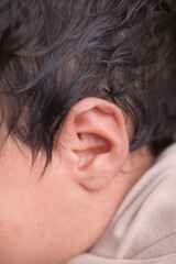 Fototapeta premium Tiny newborn baby ear body part listen 