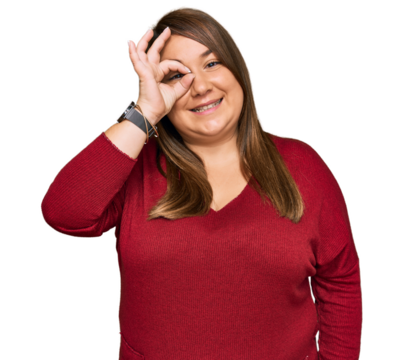 Beautiful brunette plus size woman wearing casual clothes doing ok gesture with hand smiling, eye looking through fingers with happy face.