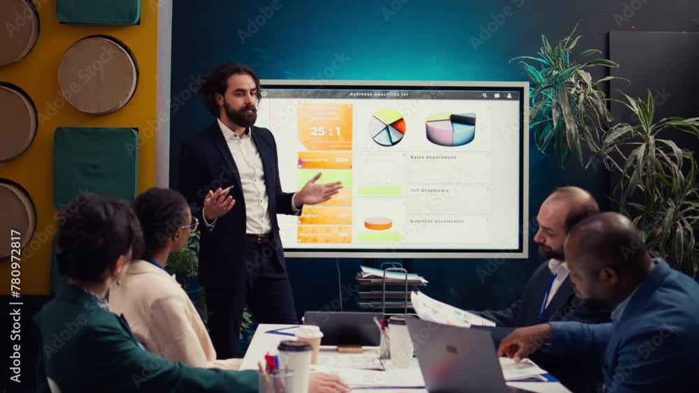 Poster team leader showing infographics data on interactive board, gathering with workers in a briefing mee