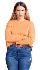 Beautiful young woman wearing casual clothes skeptic and nervous, disapproving expression on face with crossed arms. negative person.