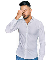 Young arab man wearing casual clothes tired rubbing nose and eyes feeling fatigue and headache. stress and frustration concept.