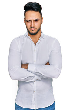 Young arab man wearing casual clothes skeptic and nervous, disapproving expression on face with crossed arms. negative person.