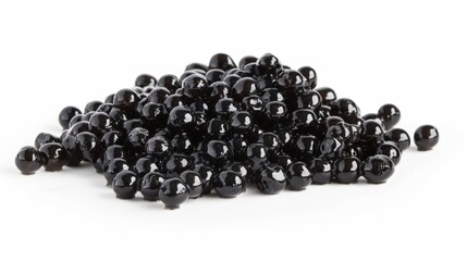 A pile of black beads on a white surface