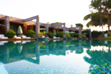 Fototapeta na wymiar Outdoor swimming pool at resort, blurred view