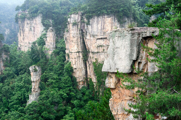 Sandstone pillars rise above the lush forest of Zhangjiajie National Forest Park in Wulingyuan...